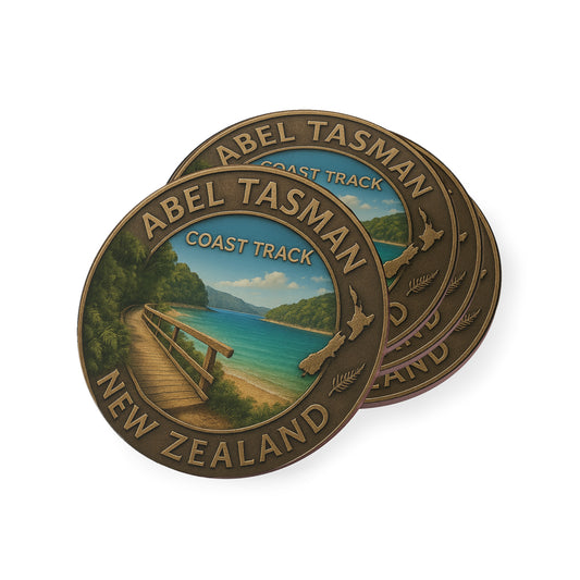 Two round metal badges featuring the Abel Tasman Coast Track New Zealand design on a white background.