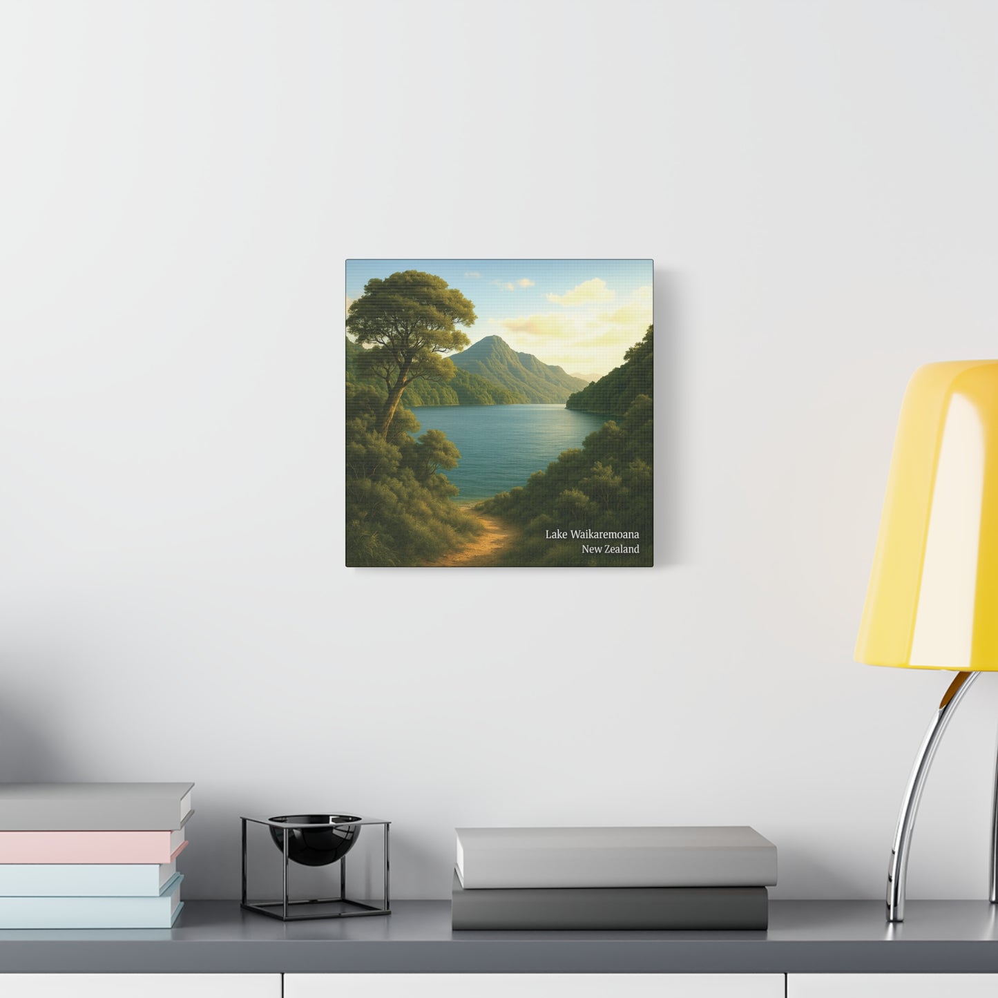 Canvas print of a mountain landscape with a lake on a wall above a desk.