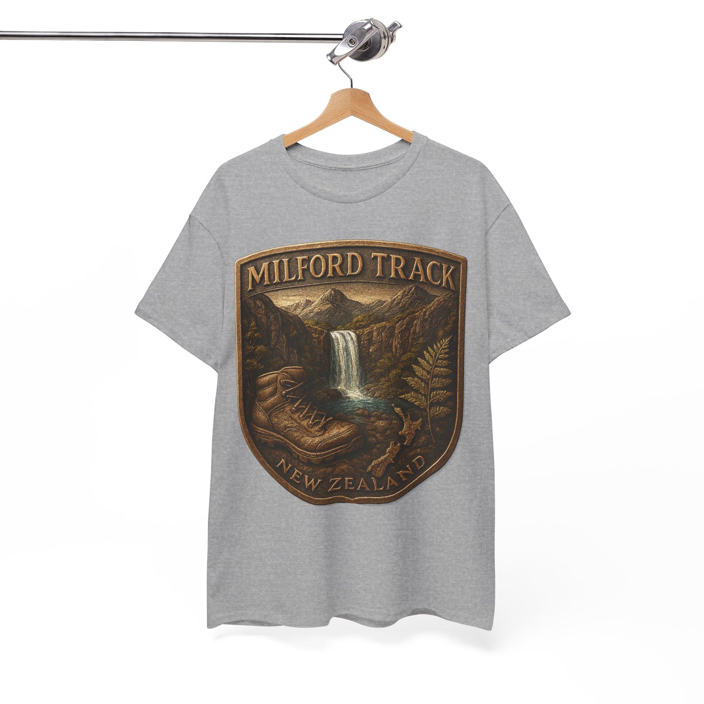 Gray t-shirt with a 'Milford Track, New Zealand' graphic on a hanger against a white background