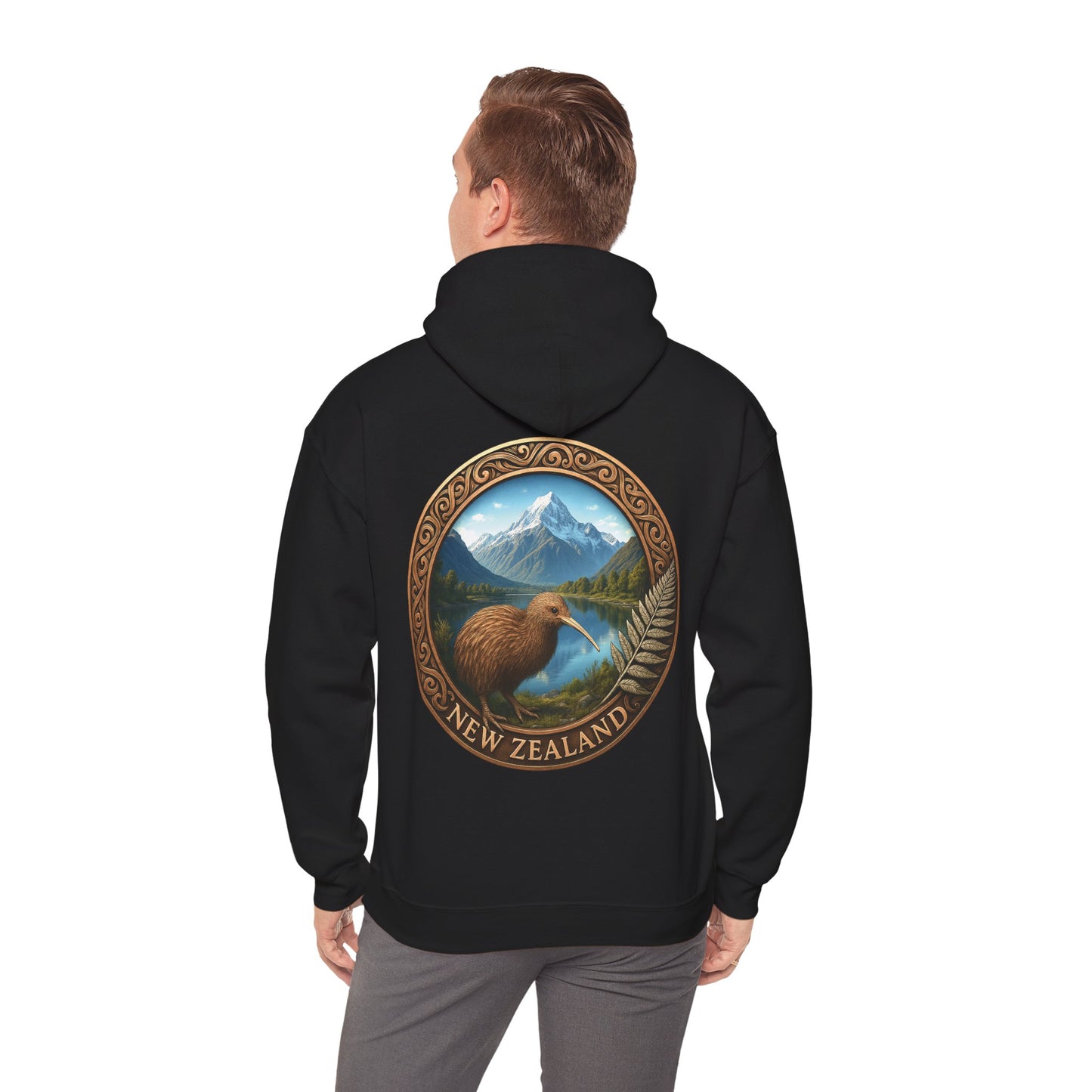 Black hoodie with a Kiwi bird and mountain design on the back, worn by a person.