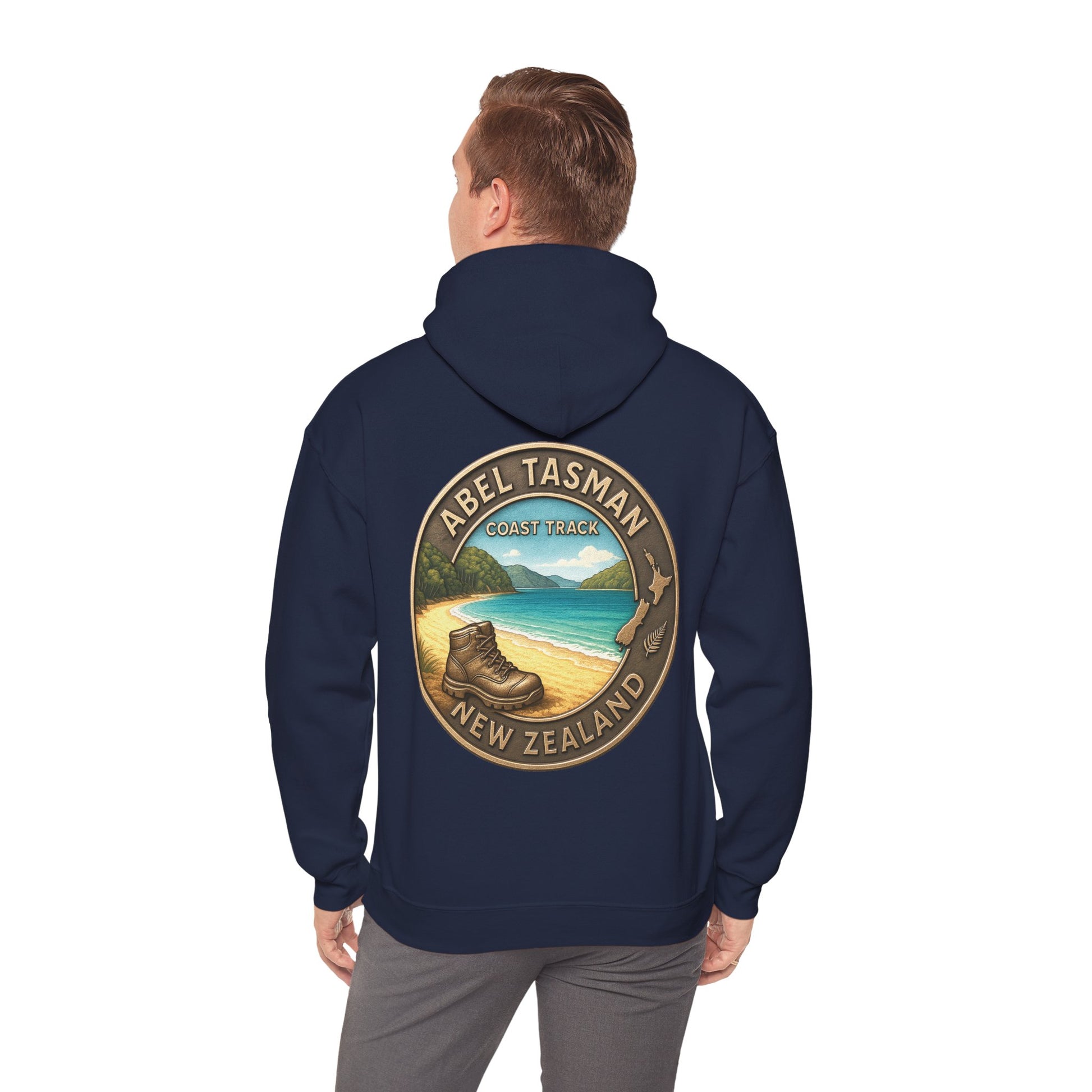 Navy blue hoodie with 'Abel Tasman Coast Track New Zealand' design on the back, worn by a person.