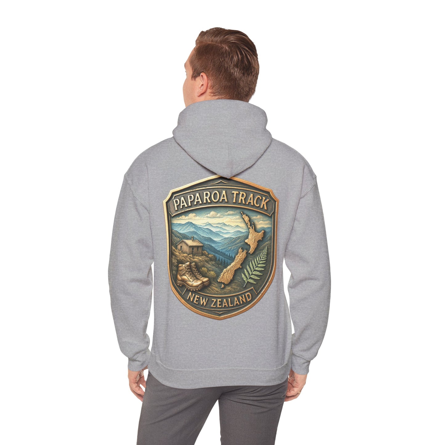 Person wearing a gray hoodie with 'Paparoa Track, New Zealand' design on the back.