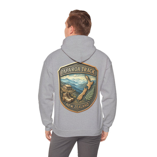 Person wearing a gray hoodie with 'Paparoa Track, New Zealand' design on the back.