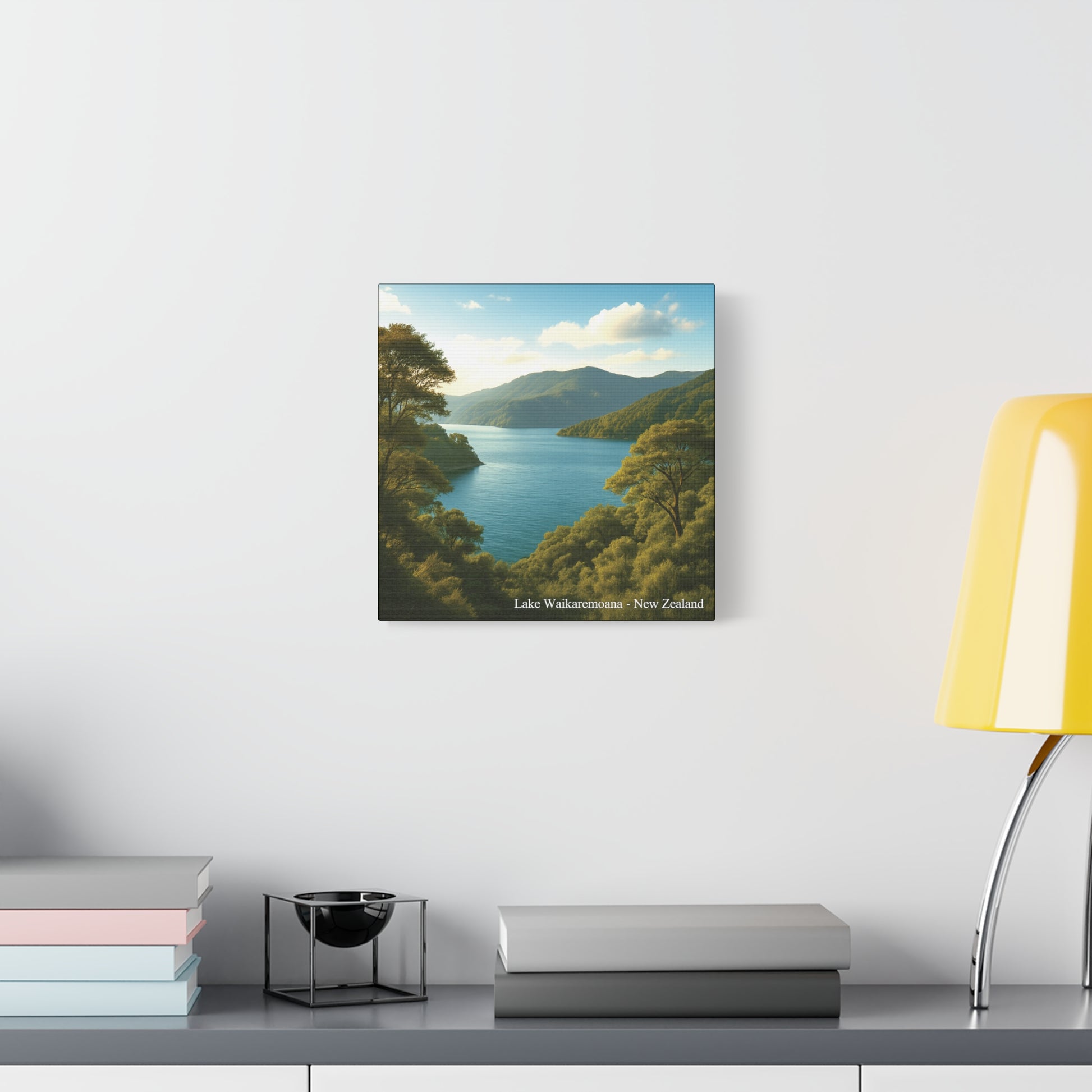 Framed Canvas landscape print of Lake Waikaremoana Track on a wall above a desk with books and a lamp.