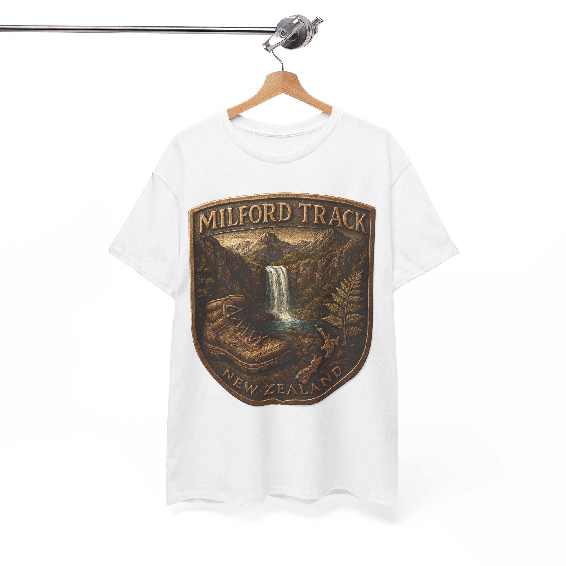White t-shirt with a 'Milford Track, New Zealand' graphic on a hanger against a white background