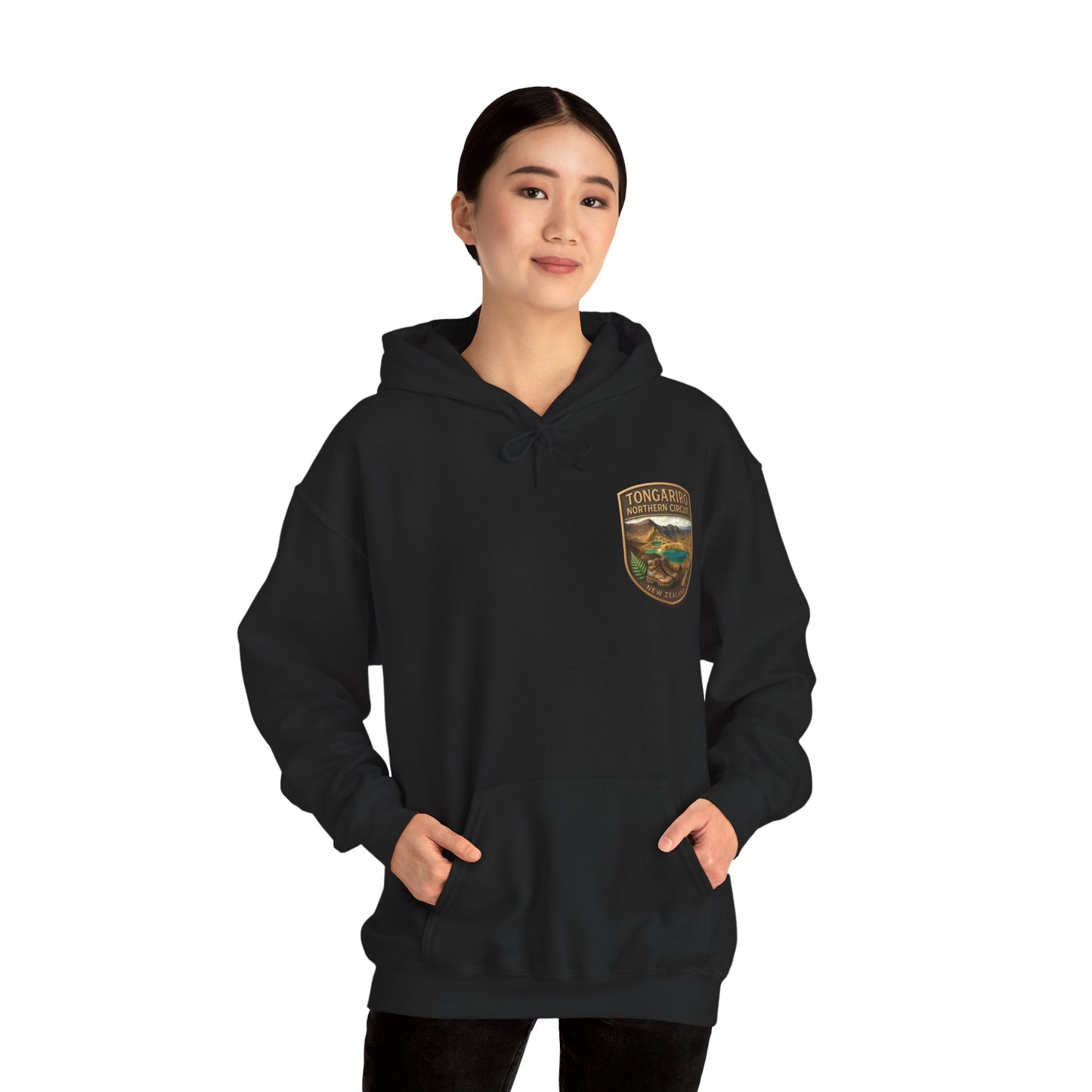 Person wearing a black Tongariro Northern Circuit hoodie with a logo on a white background