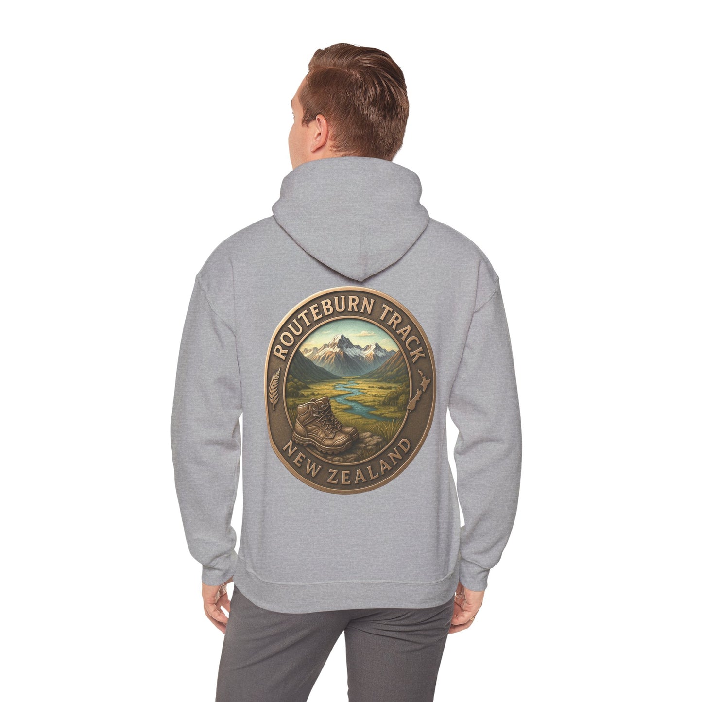 Person wearing a gray hoodie with a 'Routeburn Track, New Zealand' design on the back.