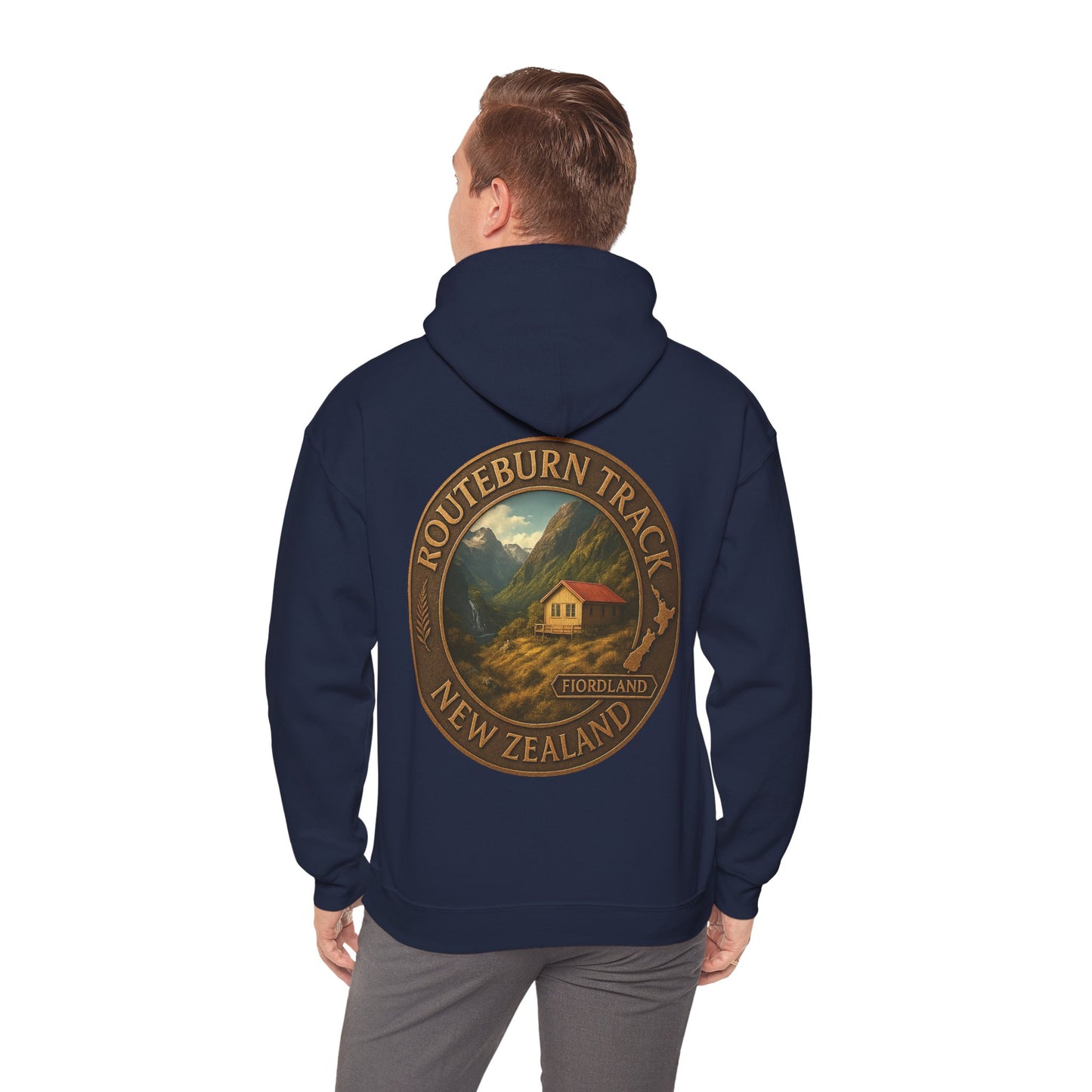 Navy blue Routeburn Track hoodie with a mountain and cabin design on the back, worn by a person.
