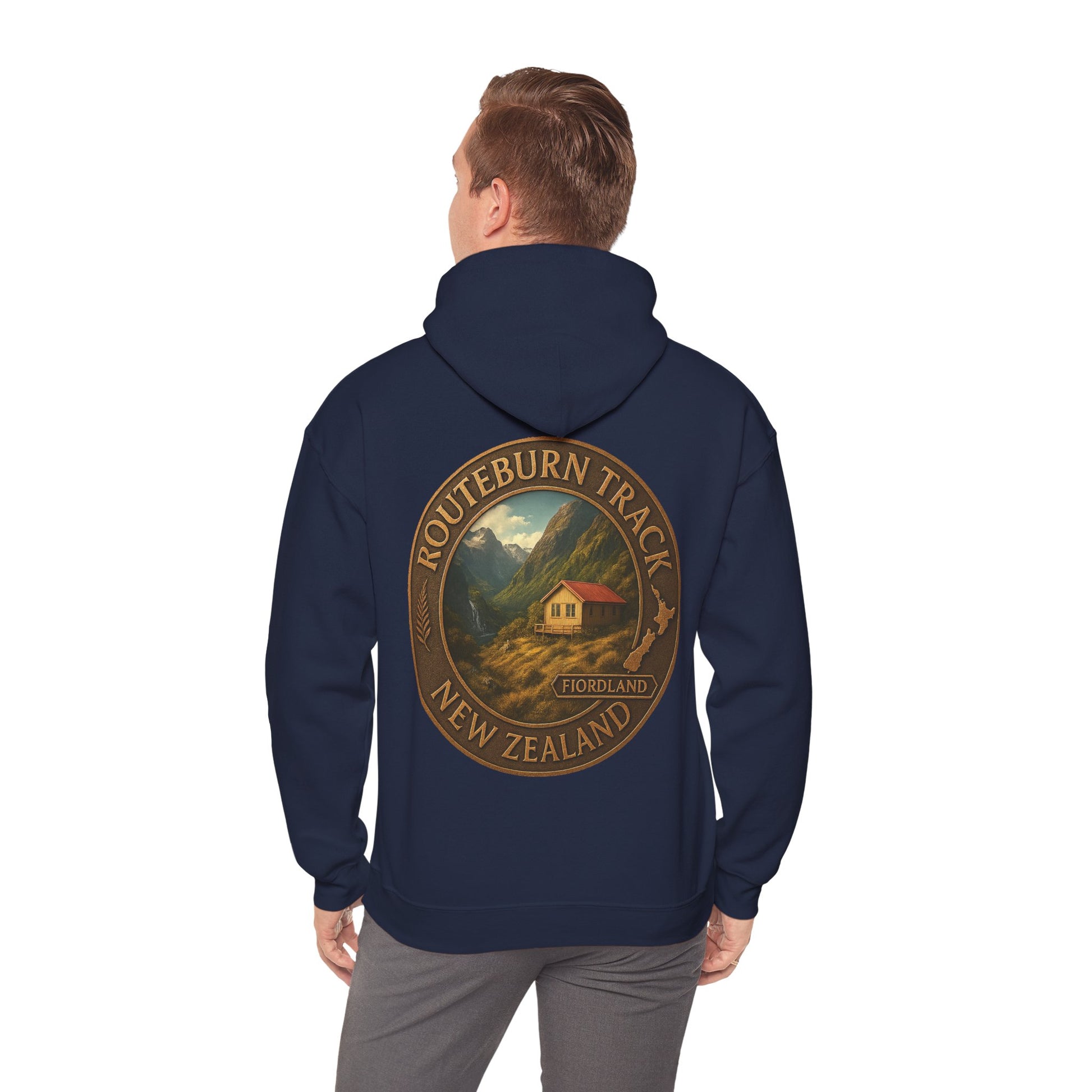 Navy blue Routeburn Track hoodie with a mountain and cabin design on the back, worn by a person.