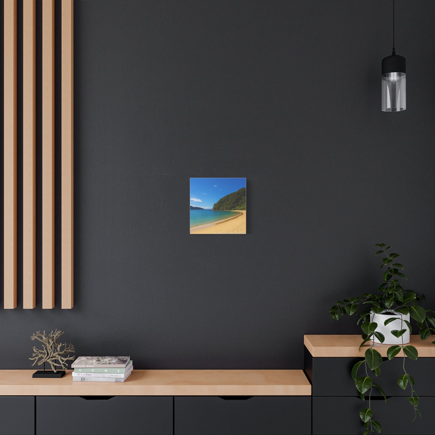 Modern interior with a beach scene print on a dark wall, wooden shelf, and decorative Abel Tasman items.