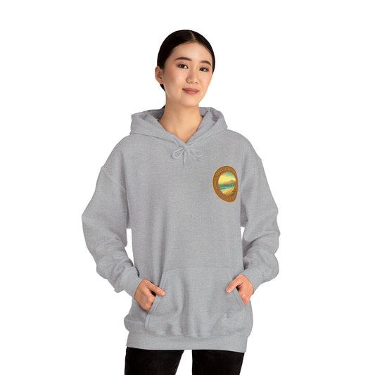 Person wearing a gray Christchurch hoodie with a logo on a white background