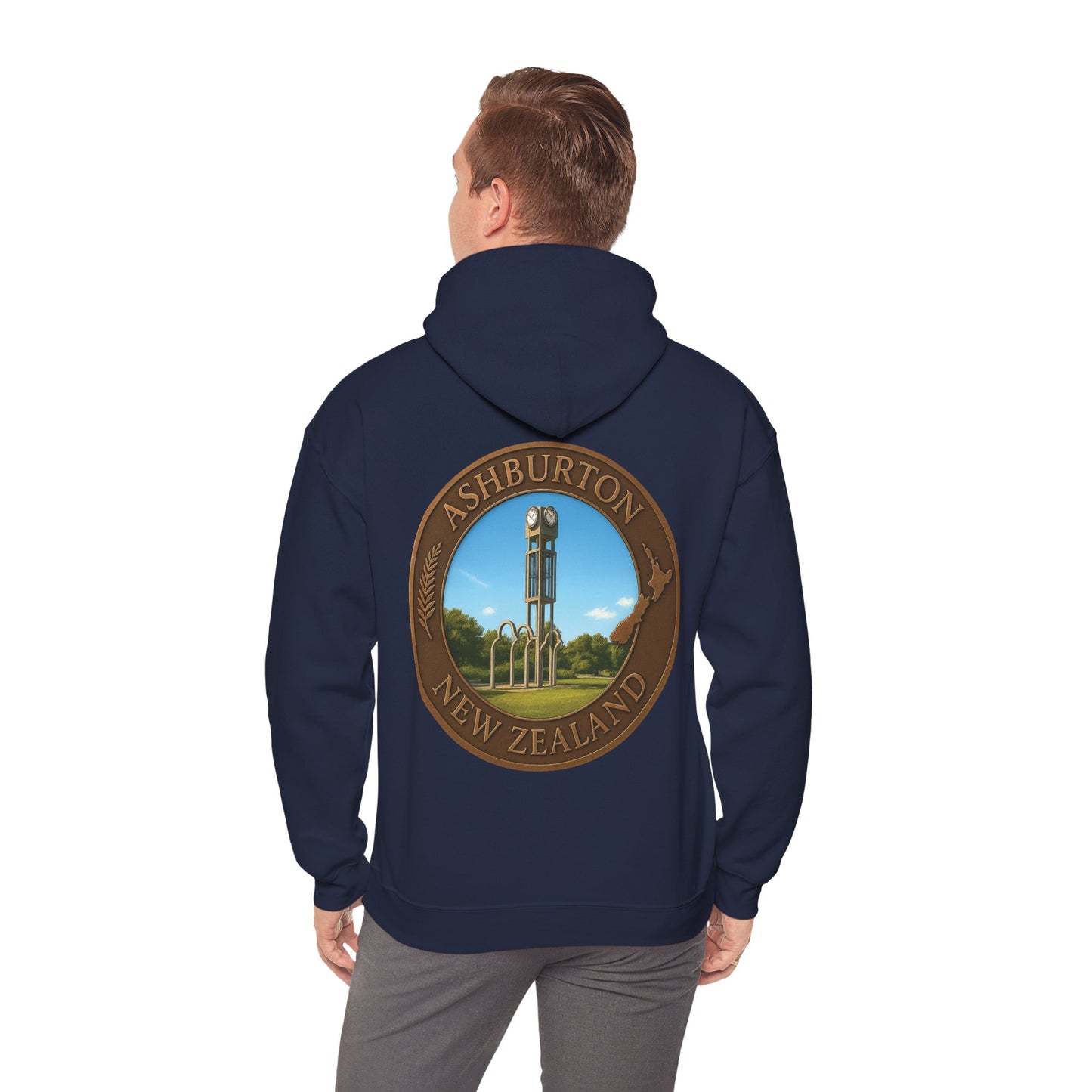 Navy blue Ashburton hoodie with a circular design on the back, featuring a scenic view and text, worn by a person.