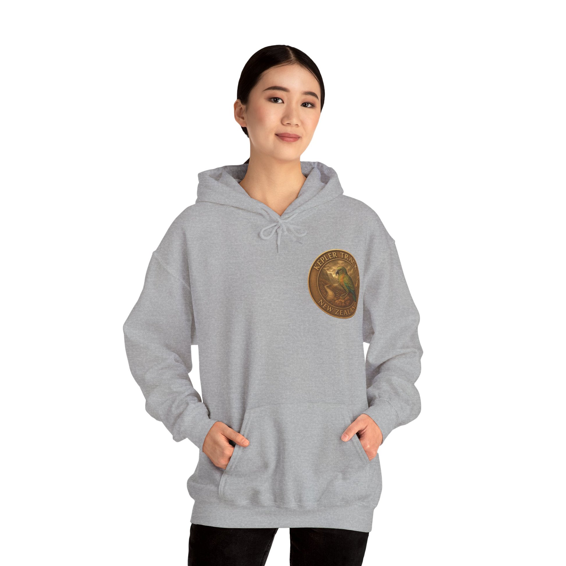 Person wearing a gray Kepler Track hoodie with a logo on a white background