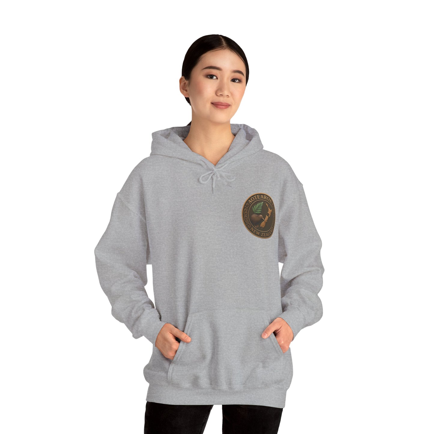 Person wearing a gray NZ hoodie with a logo on a white background