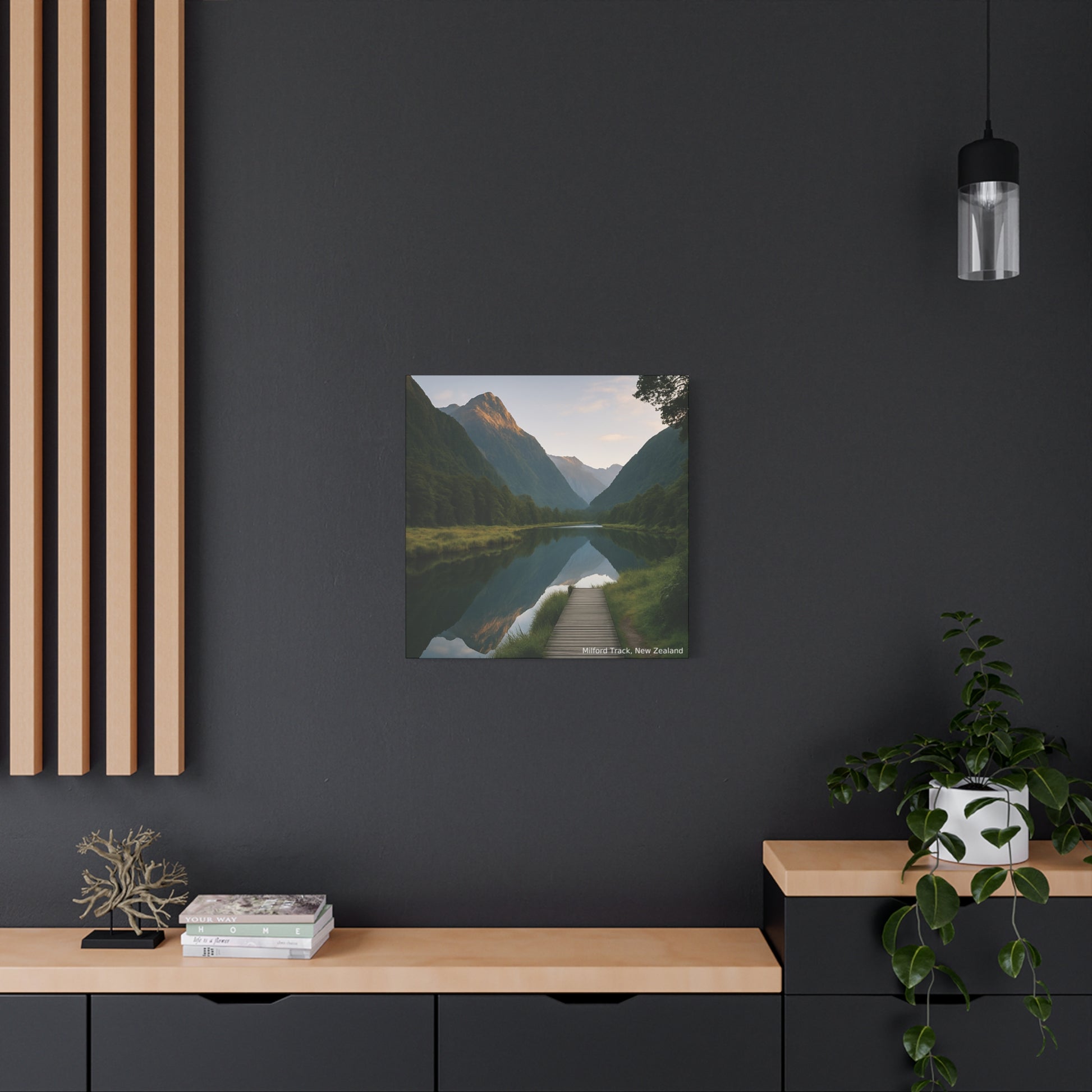 Framed landscape print of a mountain lake on a dark wall with wooden shelves and decor.