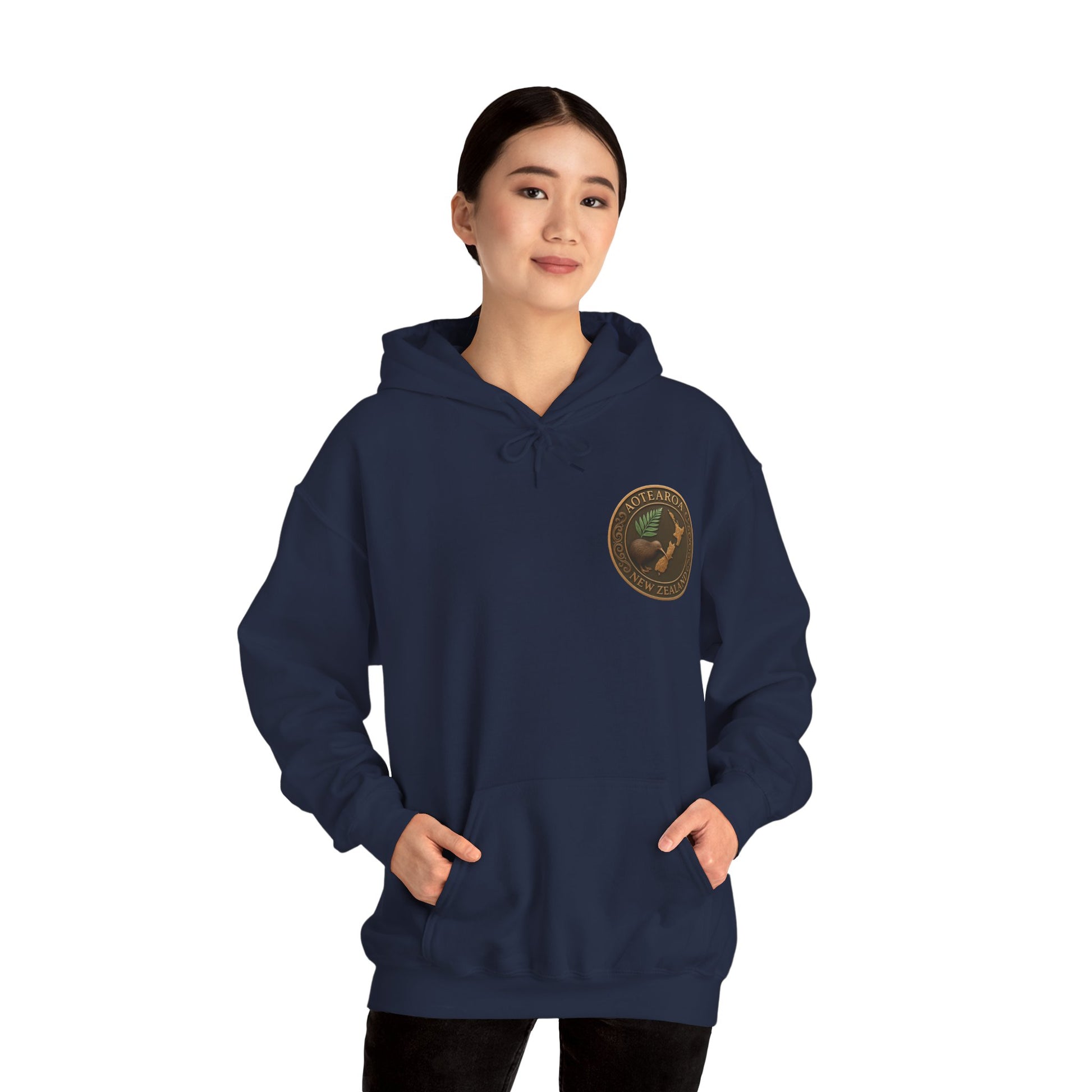 Person wearing a navy blue NZ hoodie with a logo on a white background