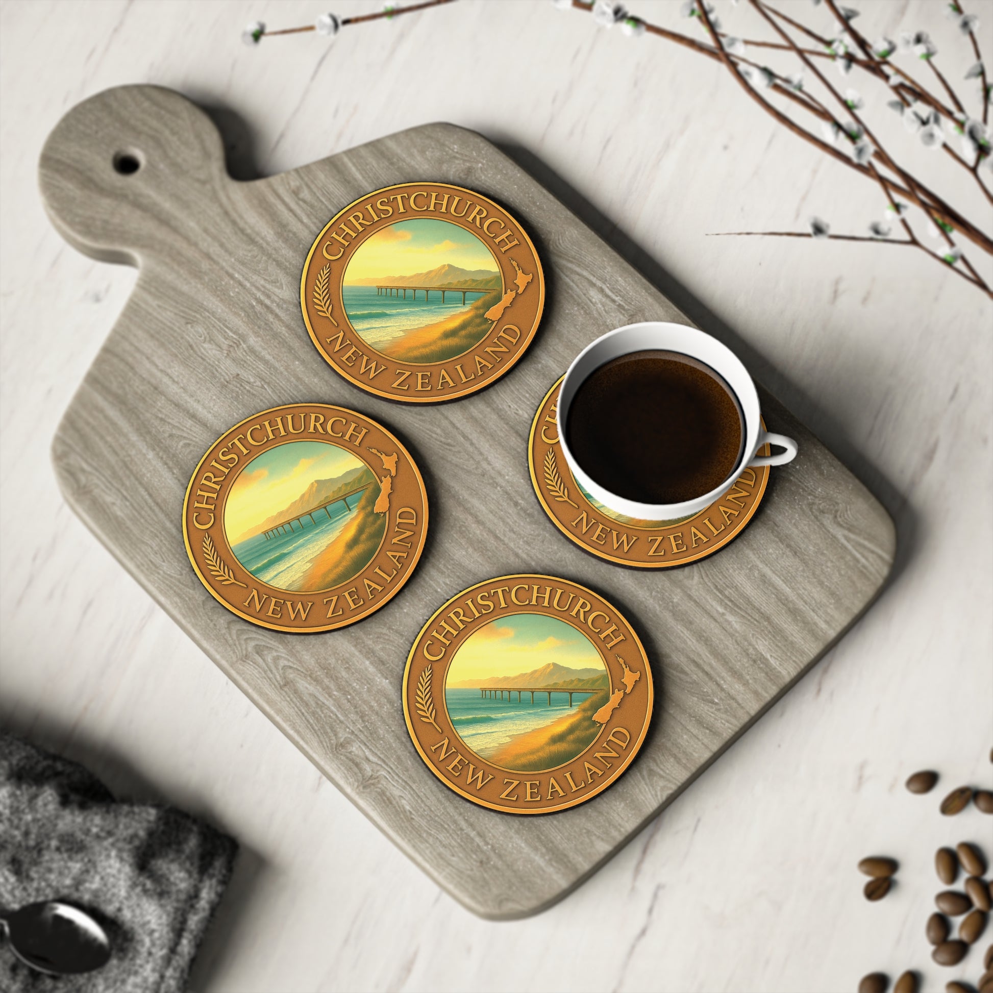 Coasters with Christchurch, New Zealand design on a wooden board with a cup of coffee.