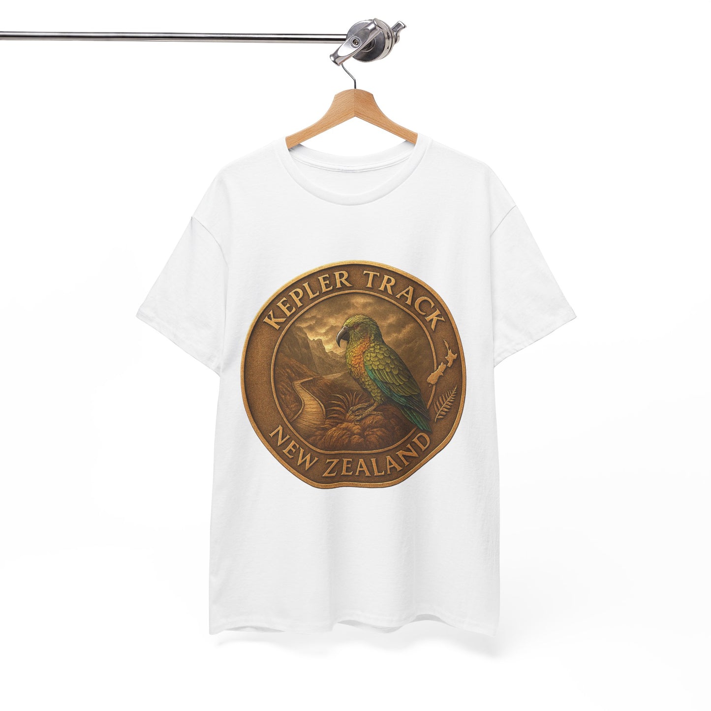 White t-shirt with a gold emblem featuring a parrot and 'Kepler Track New Zealand' text on a white background.