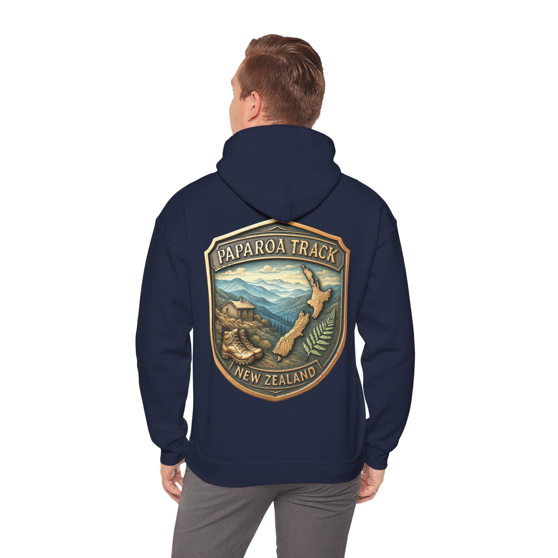 Navy blue hoodie with Paparoa Track New Zealand design on the back, worn by a person.