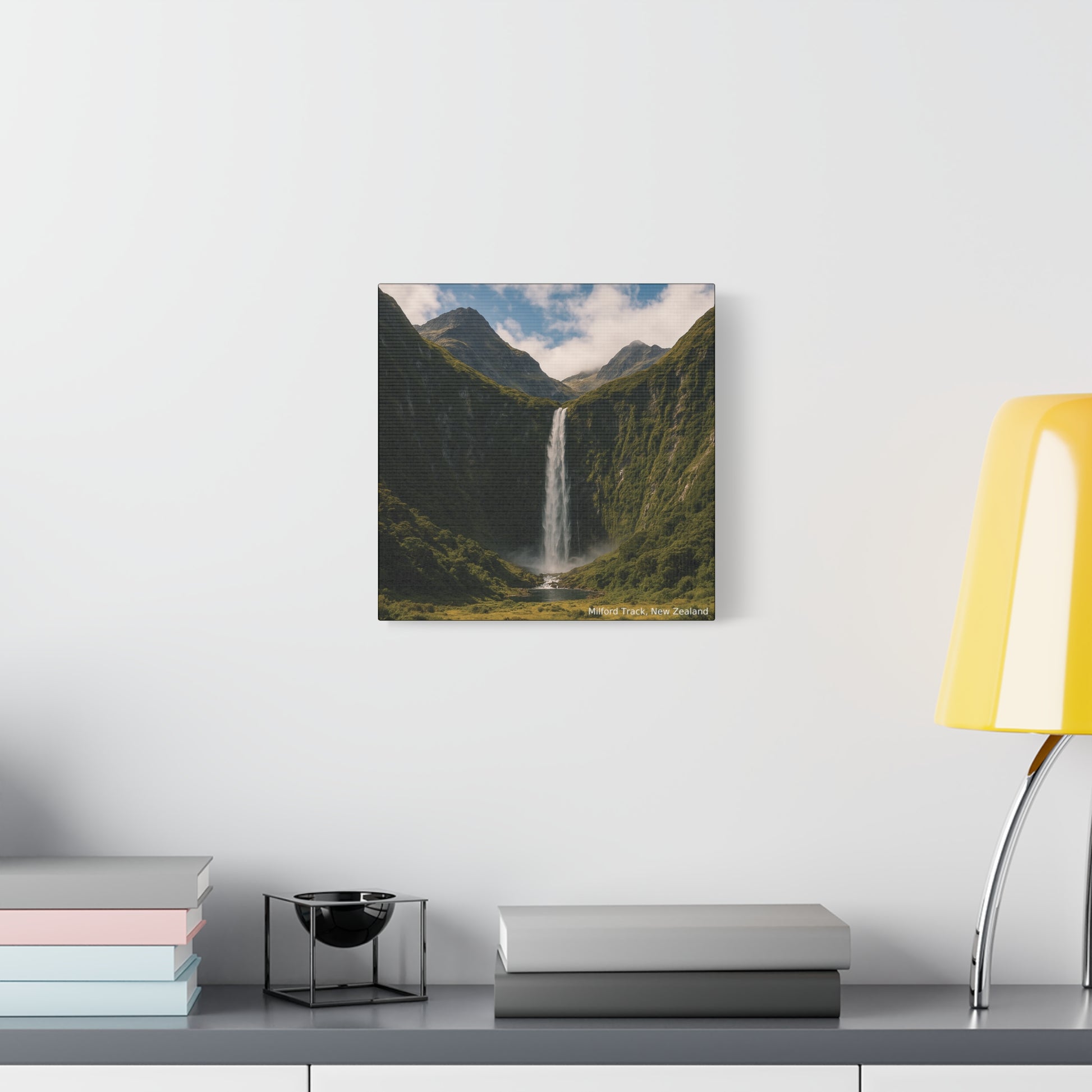Milford Track Canvas print of a mountain landscape with a waterfall on a wall above a desk.