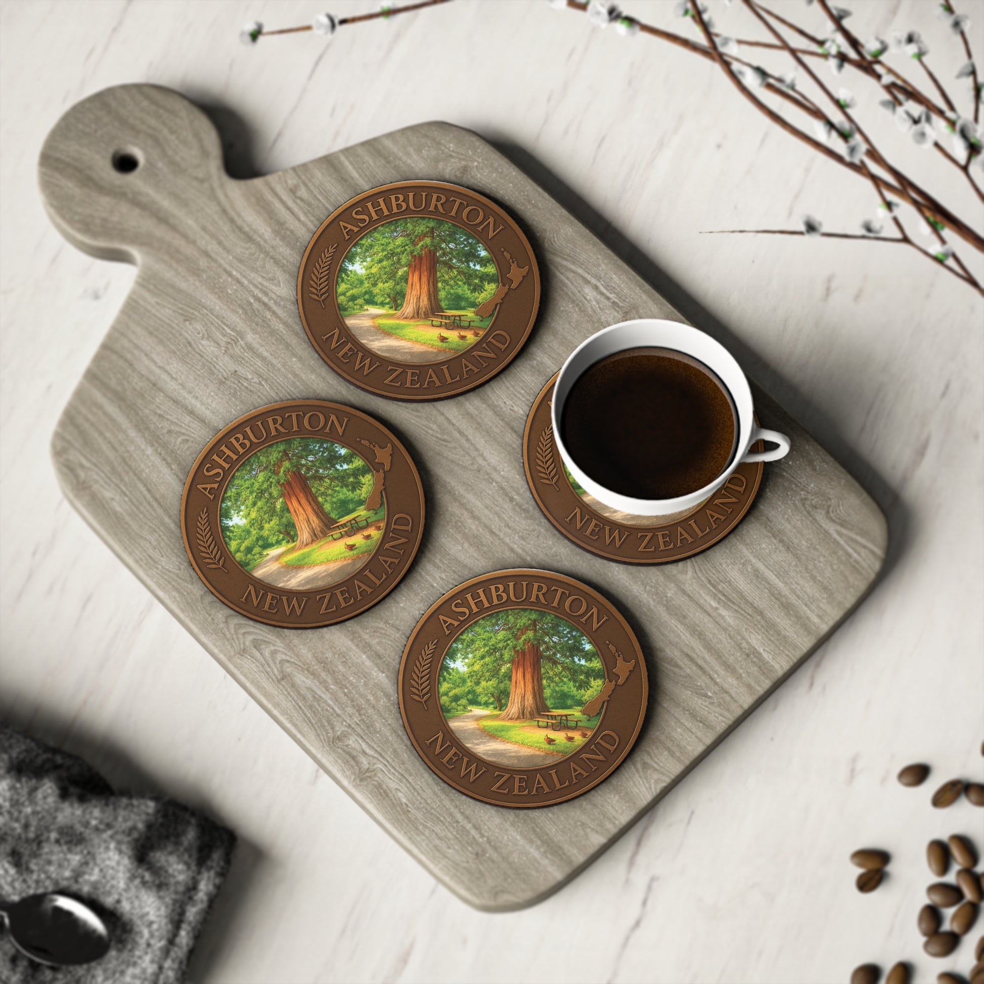 Coasters with tree design on a wooden board with a cup of coffee