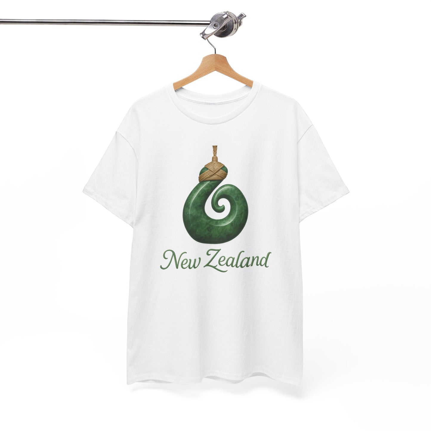White t-shirt with green spiral design and 'New Zealand' text on a hanger against a white background