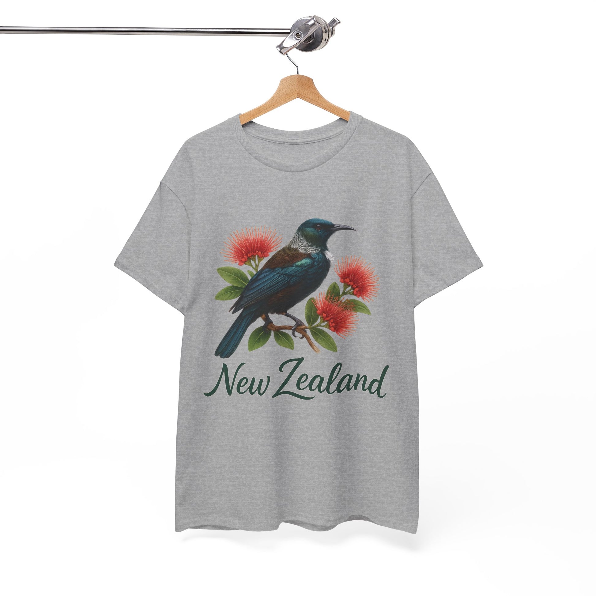 Gray t-shirt with a bird and flower design and 'New Zealand' text on a hanger against a white background