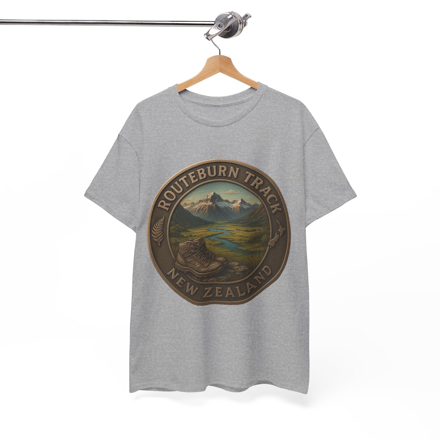 Gray t-shirt with a mountain graphic and 'Routeburn Track New Zealand' text on a hanger against a white background