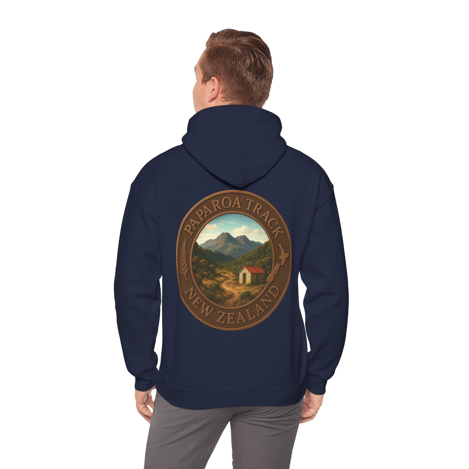 Navy blue hoodie with a Paparoa Track New Zealand design on the back, worn by a person.