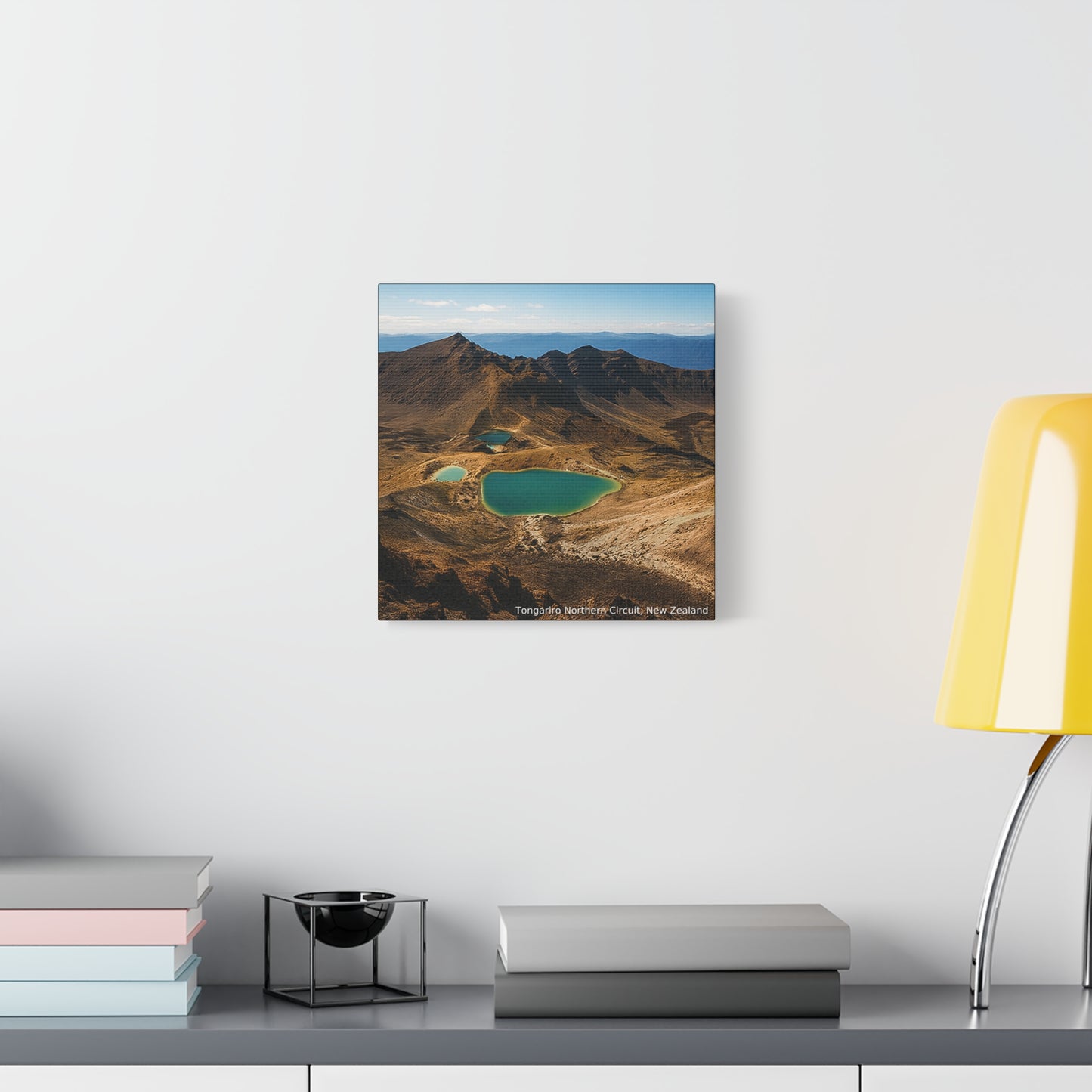 Tongariro Northern Circuit Framed Mountain landscape print on a wall above a desk with books and a lamp.