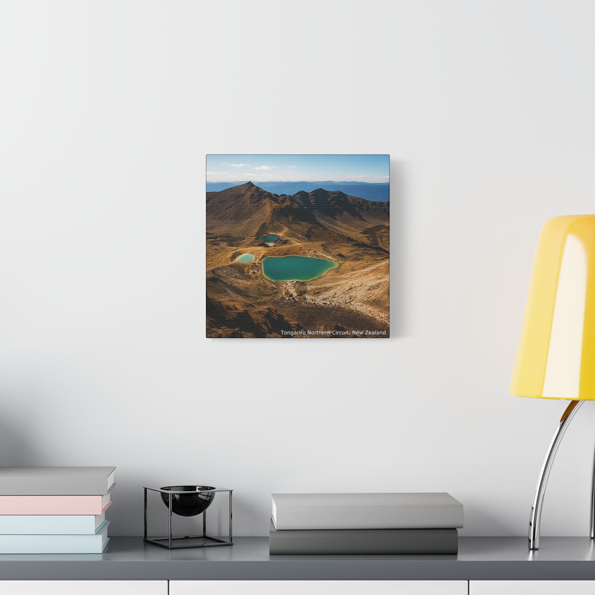 Tongariro Northern Circuit Framed Mountain landscape print on a wall above a desk with books and a lamp.