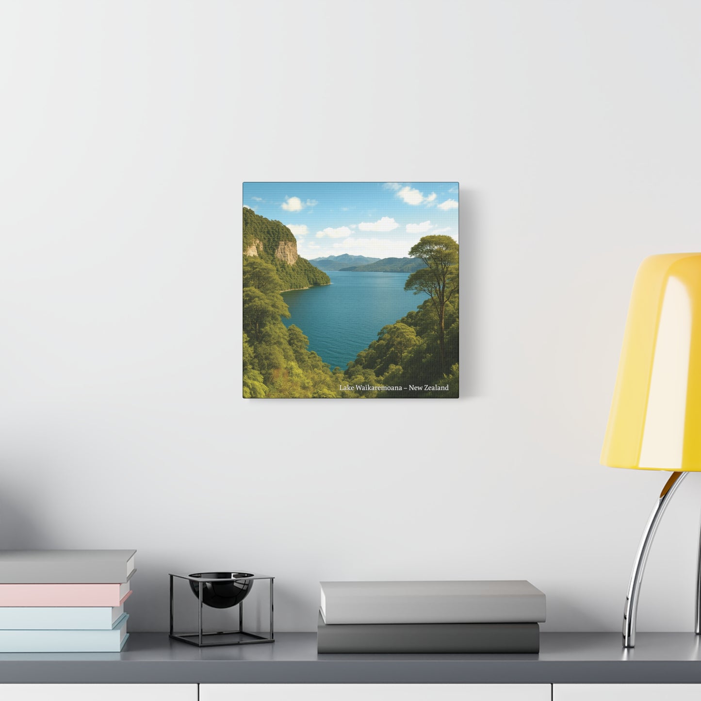 Framed Canvas landscape print of a lake with Lake Waikaremoana Track mountains on a wall above a desk.