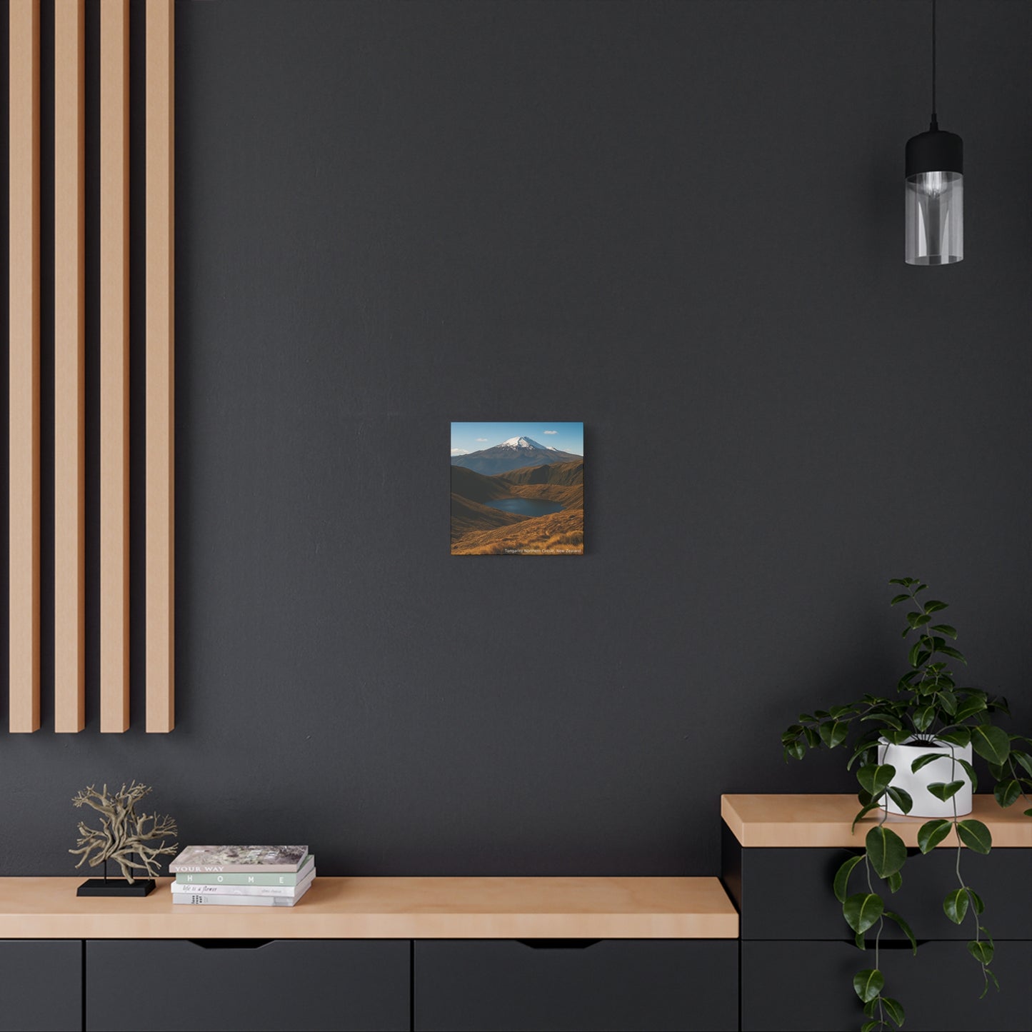 Modern interior with a dark wall, wooden shelf, and decorative items.