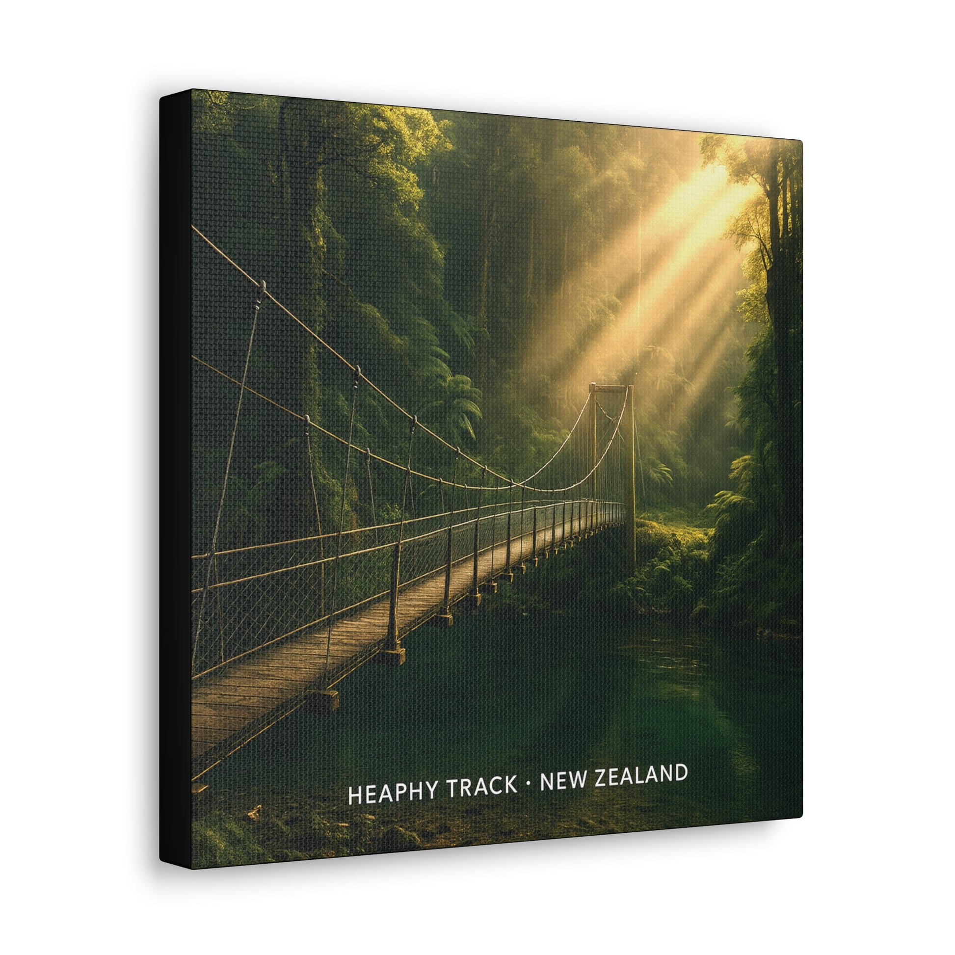 Canvas print of a suspension bridge in a forest with sunlight beams, featuring 'Heaphy Track, New Zealand' text.