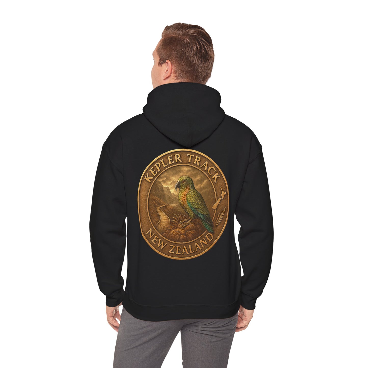 Person wearing a black Kepler Track hoodie with a gold emblem and parrot design on the back, on a white background.