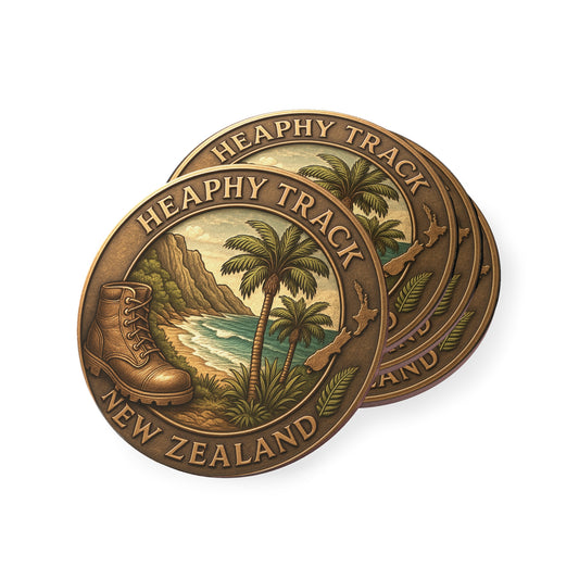 Bronze coin with 'Heaphy Track New Zealand' design featuring palm trees and a boot.