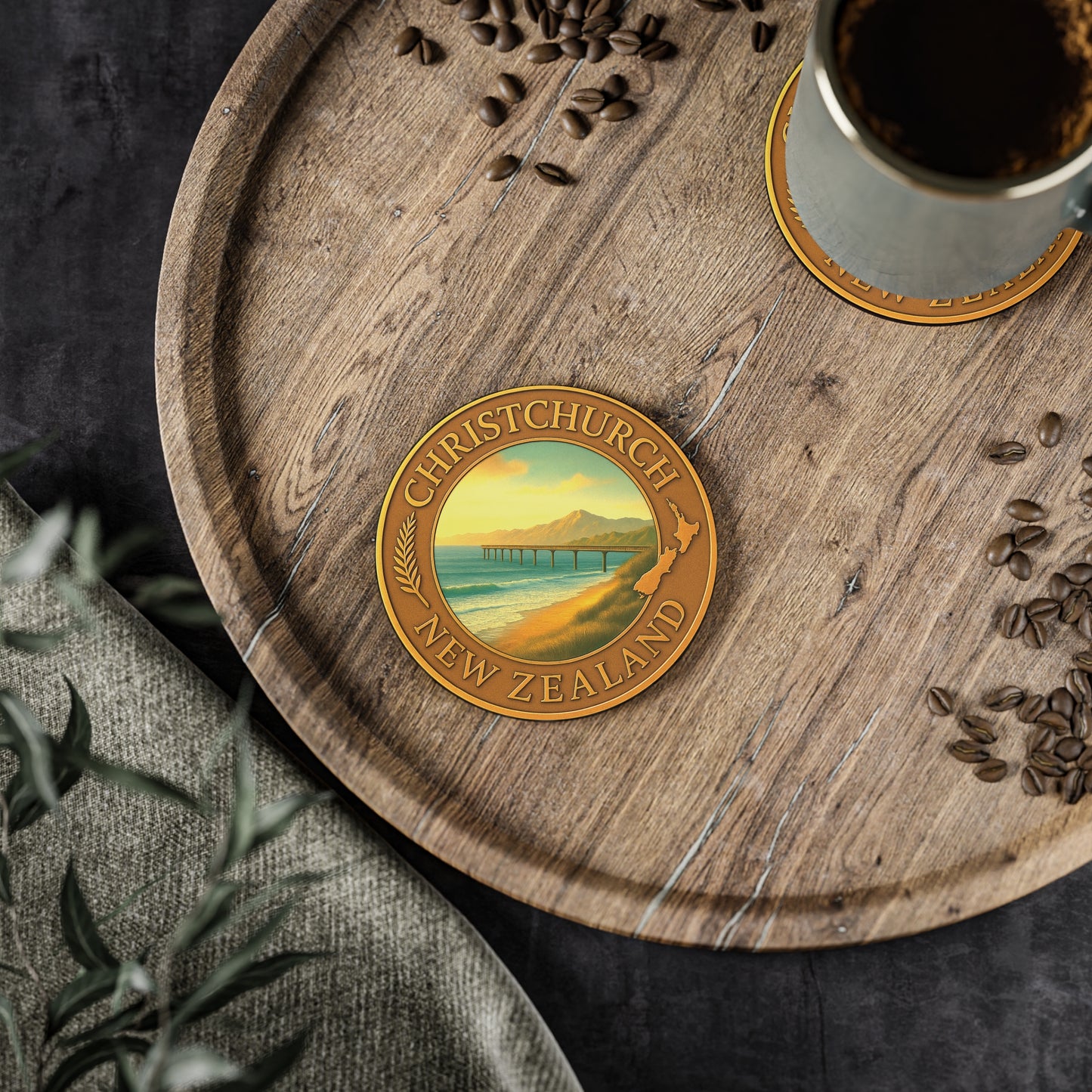 Coaster with Christchurch, New Zealand design on a wooden tray with coffee and seeds.