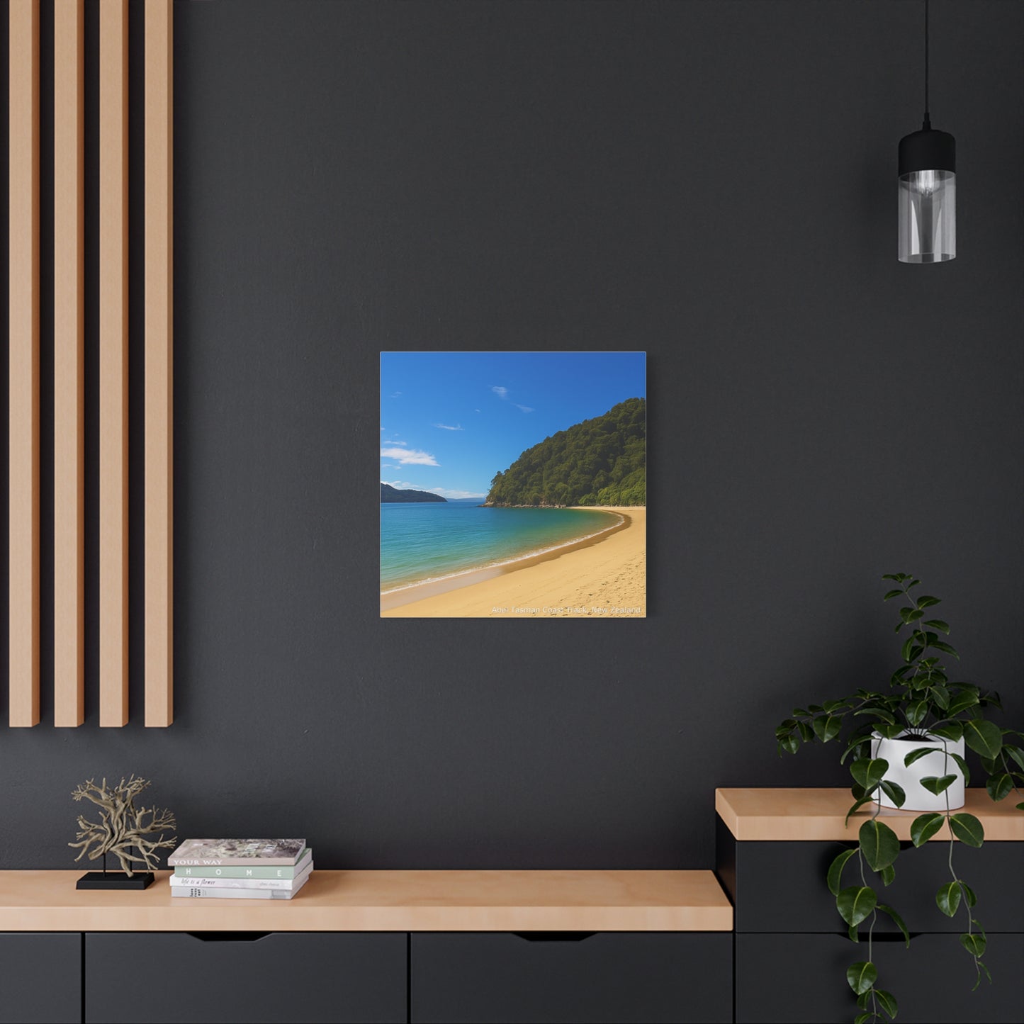 Abel Tasman Beach scene artwork on a dark wall with wooden shelves and decor.