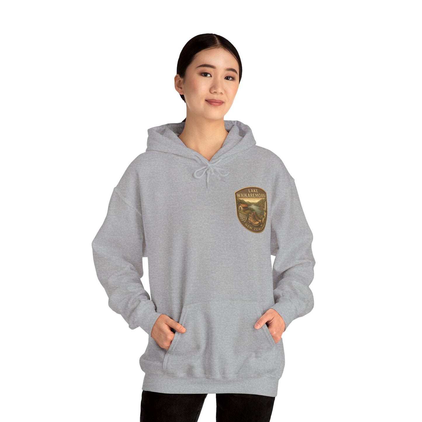 Person wearing a gray Lake Waikaremoana Track hoodie with a logo on a white background