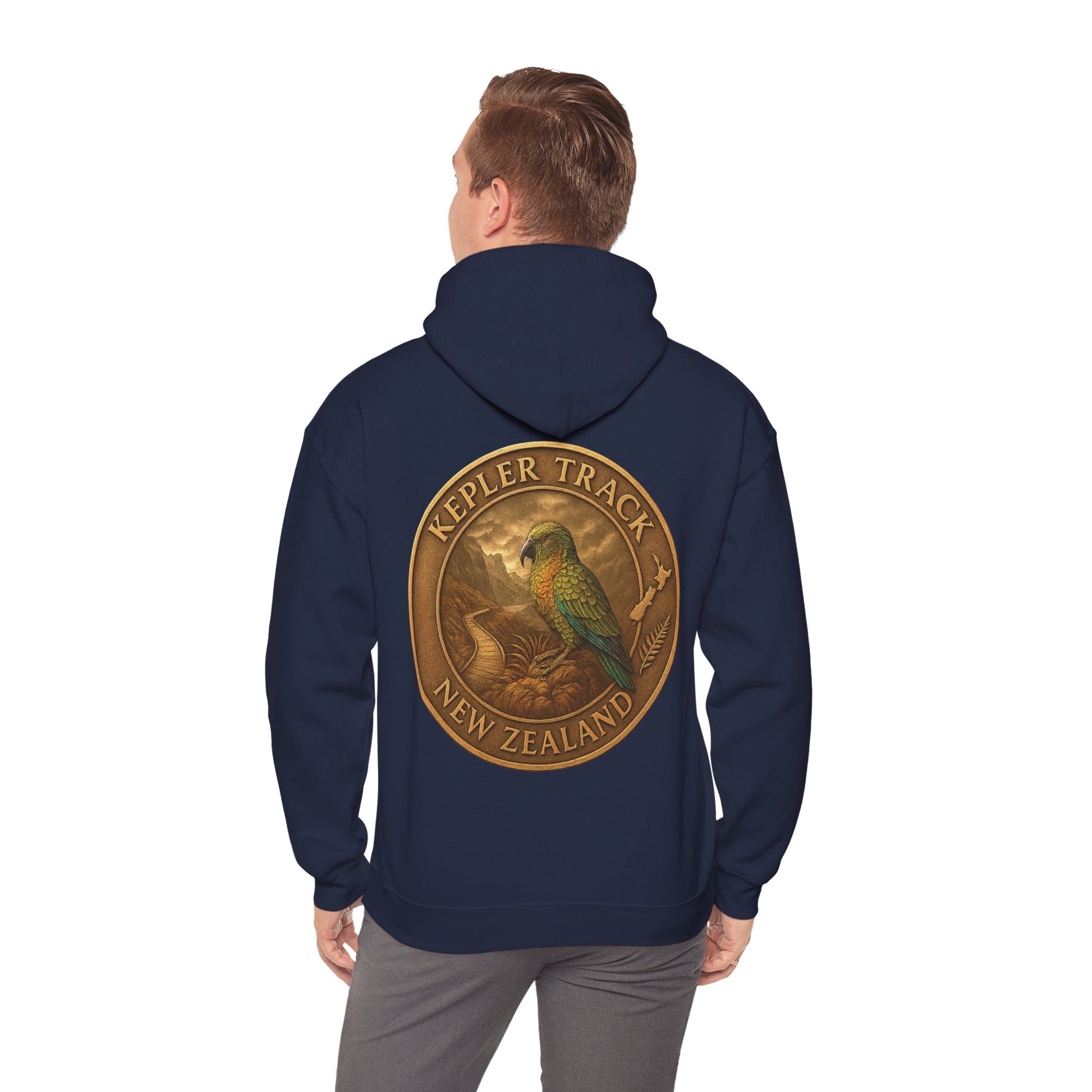 Navy blue Kepler Track hoodie with a gold and green emblem on the back, worn by a person.