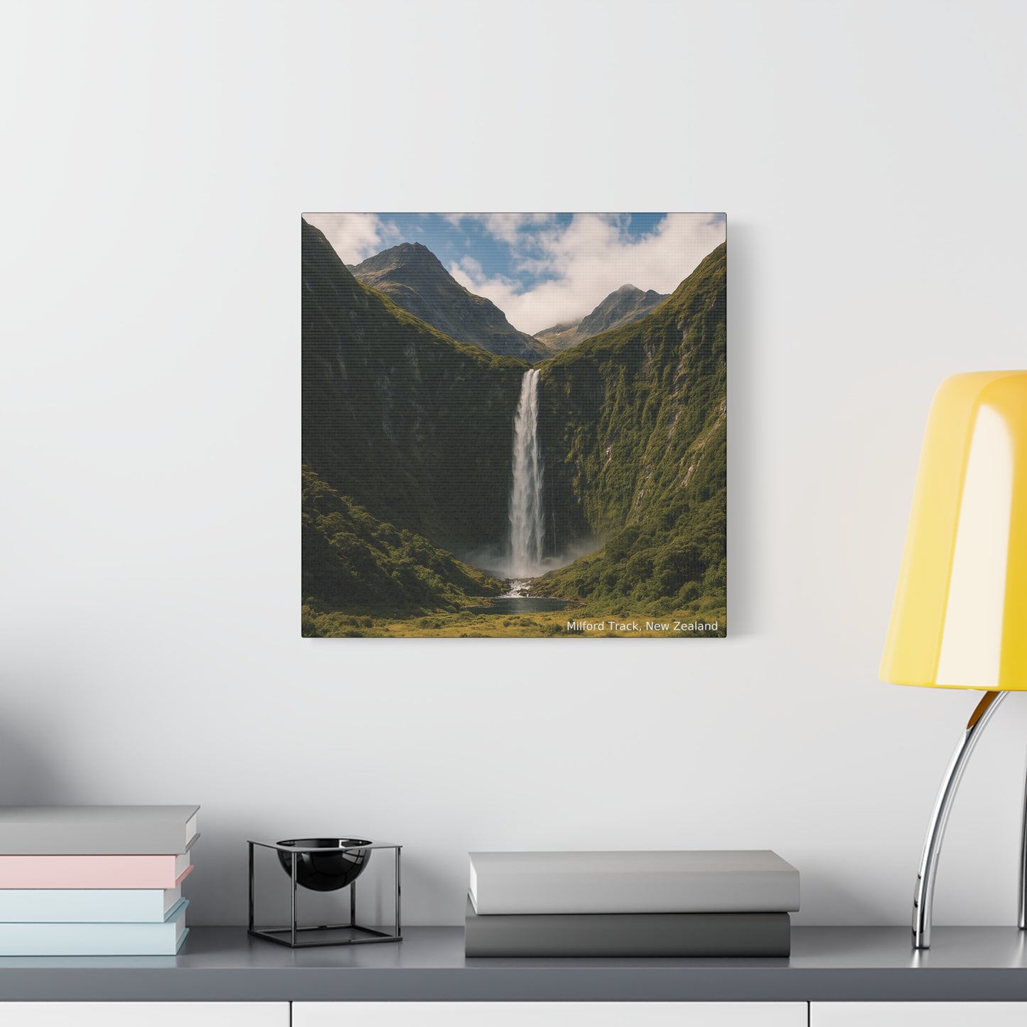 Milford Track Canvas print of a mountain landscape with a waterfall on a wall above a shelf.