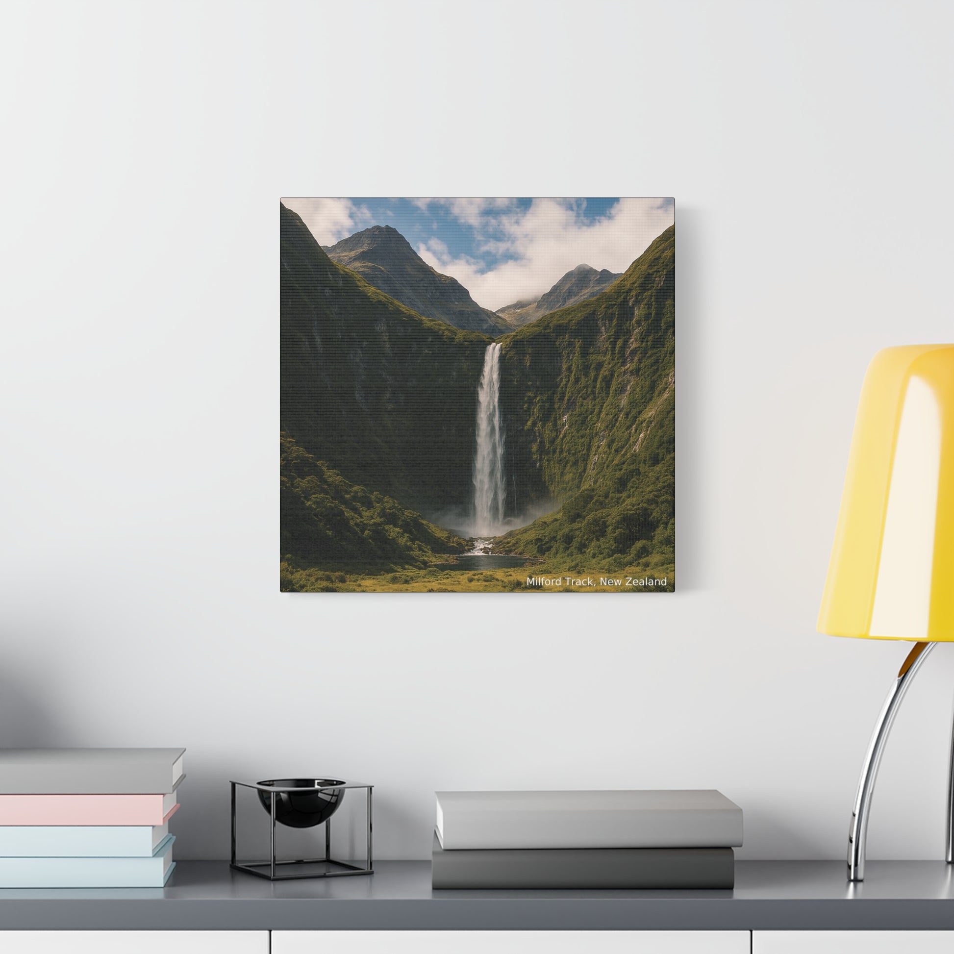 Milford Track Canvas print of a mountain landscape with a waterfall on a wall above a shelf.