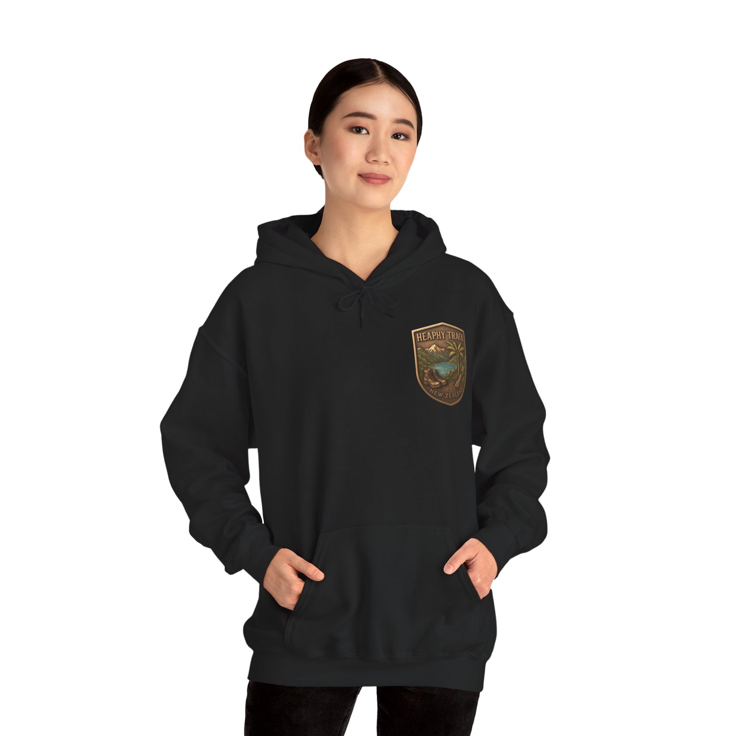 Person wearing a black Heaphy Track hoodie with a logo on the chest against a white background