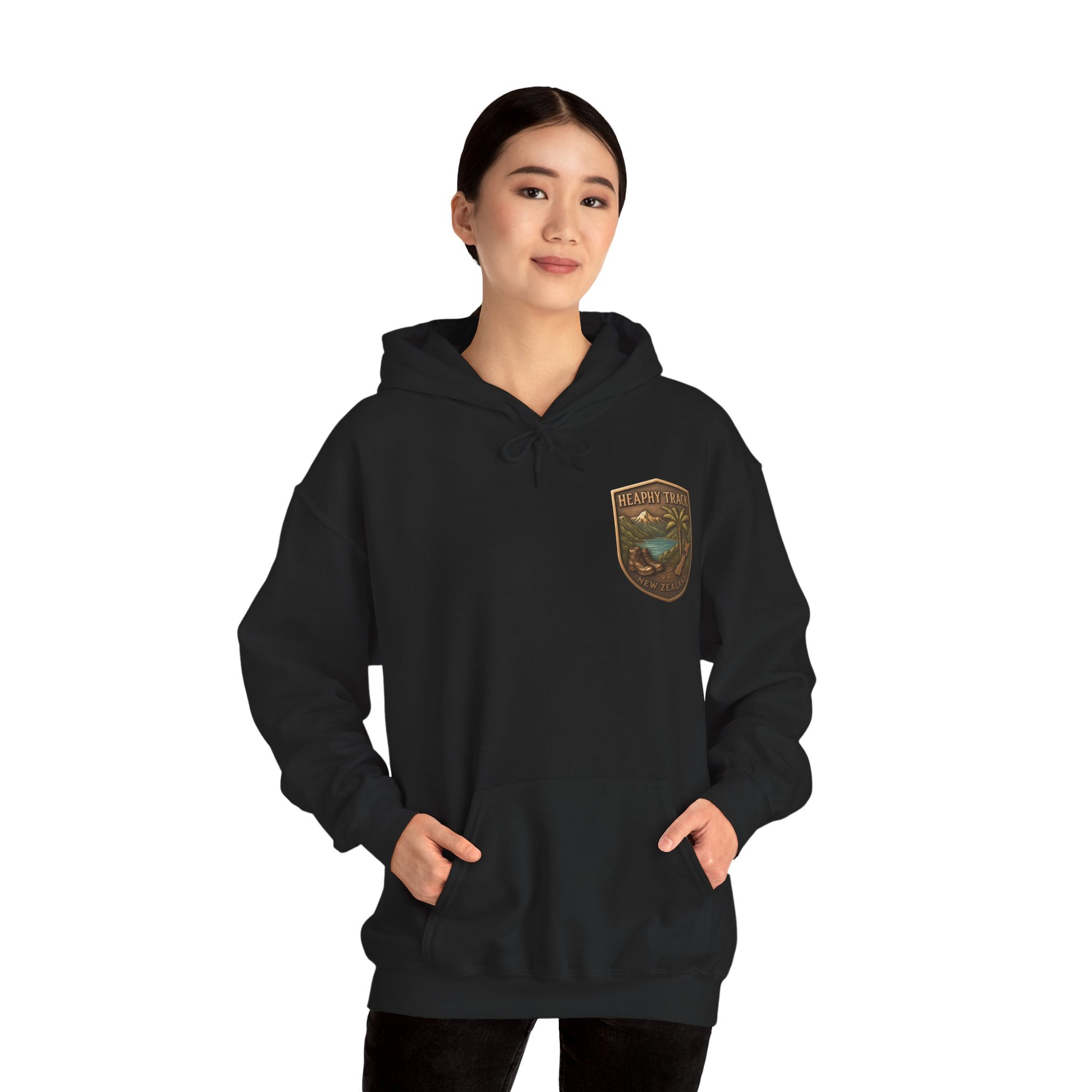 Person wearing a black Heaphy Track hoodie with a logo on the chest against a white background